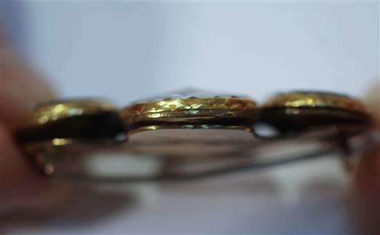 Four late 17th century gold mounted Stuart crystal oval slides later mounted together as a brooch, width 54mm.